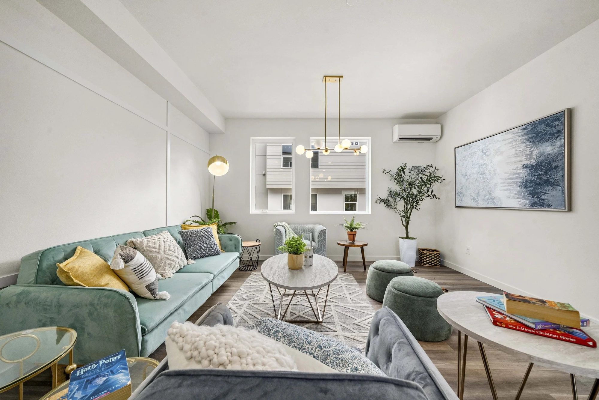 Modern living room with green sofa and pendant lighting